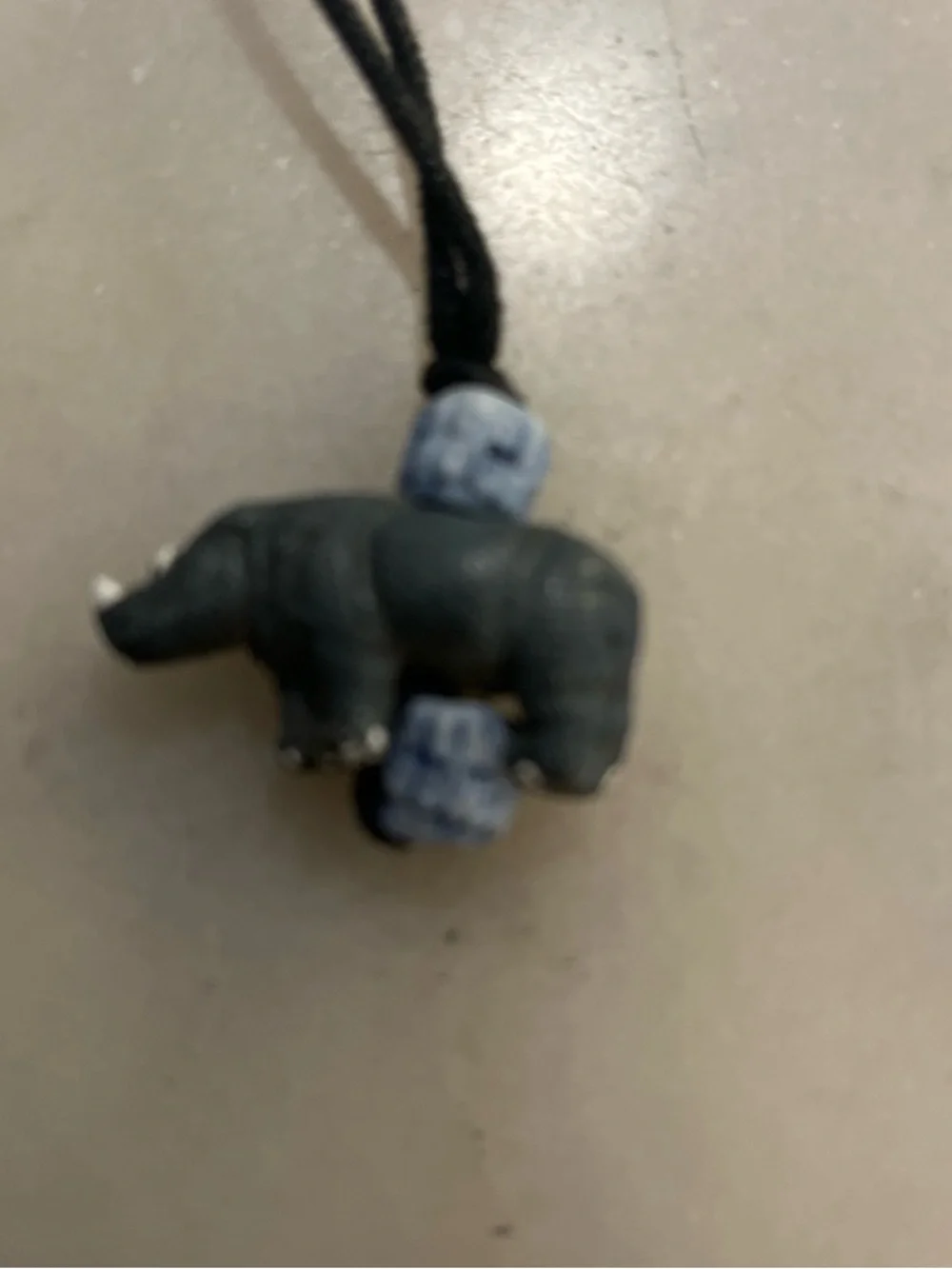 Handcrafted Dark Gray Rhinoceros Pendant Necklace with Blue Beads